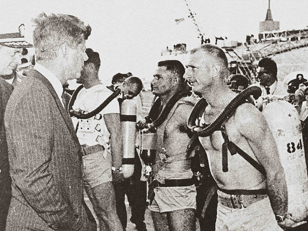 President John F. Kennedy speaking with U.S. Navy Seal divers wearing the Fifty Fathoms